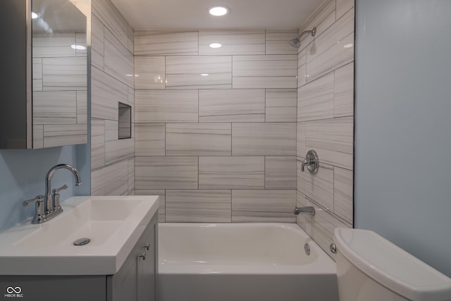 bathroom with shower / bath combination, toilet, and vanity