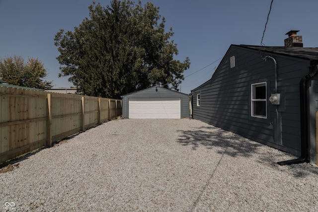 view of yard with a garage, an outdoor structure, and fence