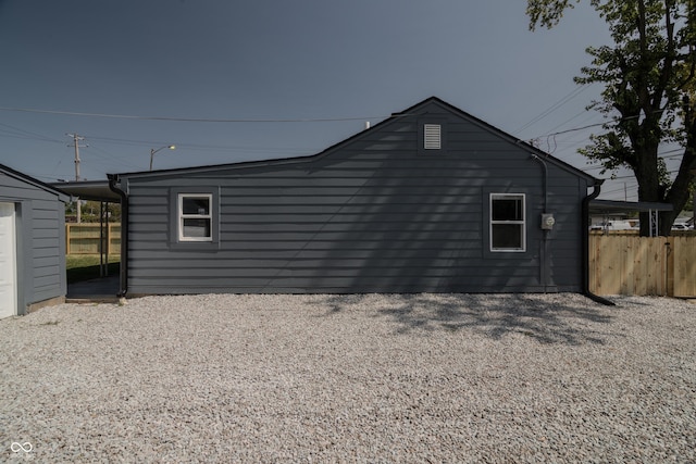 view of property exterior featuring fence