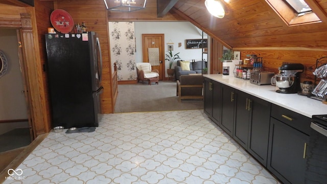114 N Grant Ave, Crawfordsville, IN 47933 - kitchen featuring light countertops, wood walls, lofted ceiling with skylight, wooden ceiling, and freestanding refrigerator