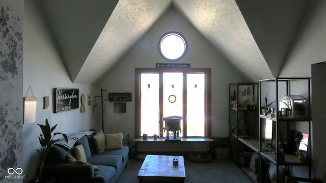 carpeted living room featuring vaulted ceiling