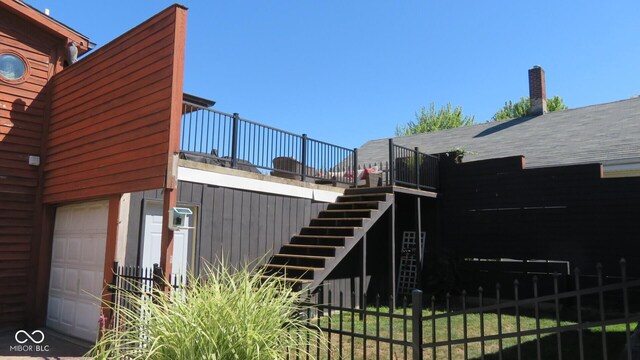 114 N Grant Ave, Crawfordsville, IN 47933 - view of home's exterior with an attached garage, fence, and stairway