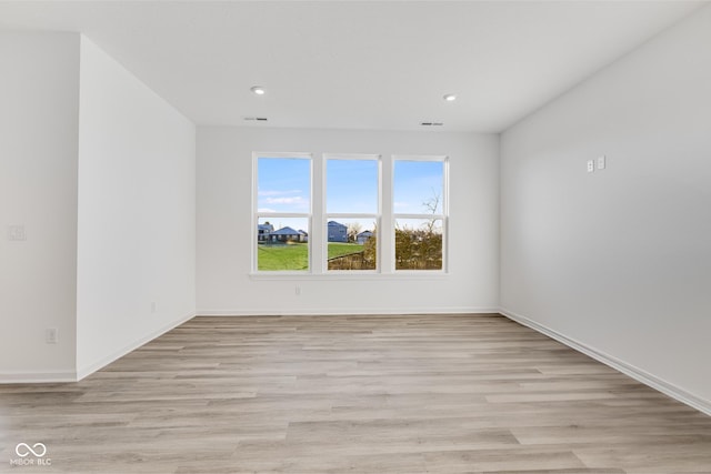 spare room featuring light hardwood / wood-style flooring