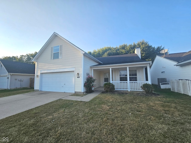 view of front of home with cooling unit, a front yard, a porch, and a garage