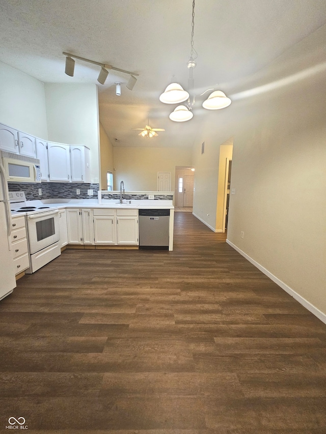 kitchen with decorative light fixtures, white cabinets, white appliances, dark hardwood / wood-style floors, and decorative backsplash