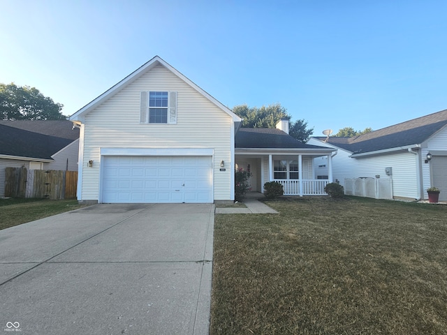 view of property with a garage, a front lawn, and covered porch