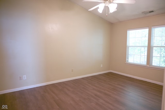 empty room with ceiling fan, dark wood-type flooring, and lofted ceiling