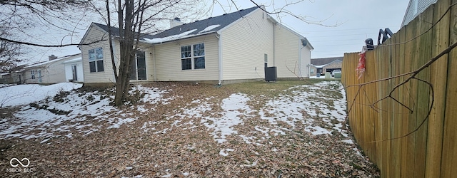 snow covered property featuring central AC