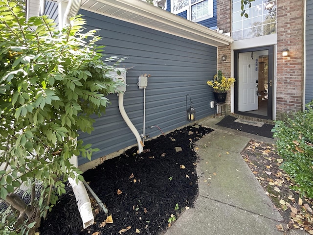 property entrance featuring brick siding