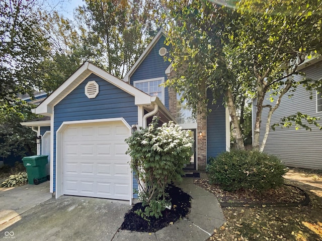 exterior space featuring driveway, brick siding, and a garage