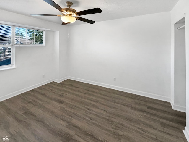 spare room with ceiling fan and dark hardwood / wood-style floors