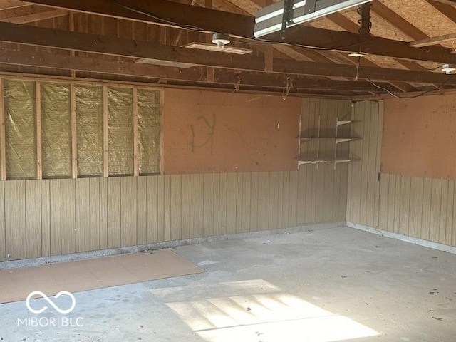 garage featuring wood walls