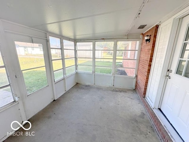 unfurnished sunroom featuring visible vents