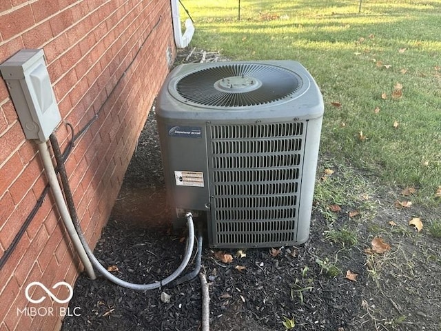 exterior details with central AC unit and brick siding