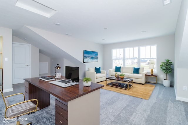 carpeted office featuring lofted ceiling