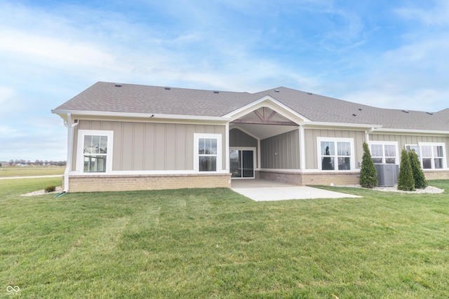 back of house with a lawn, central AC, and a patio