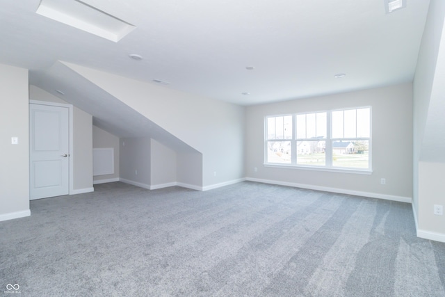 additional living space with carpet flooring and lofted ceiling