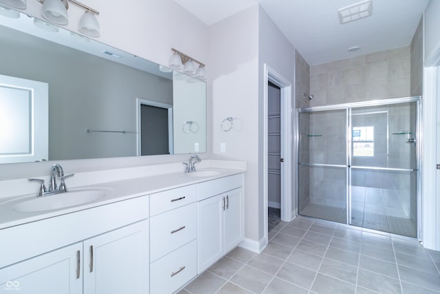 bathroom featuring tile patterned flooring, vanity, and an enclosed shower