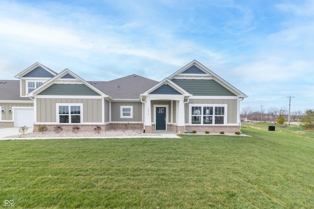 craftsman house featuring a front yard and a garage