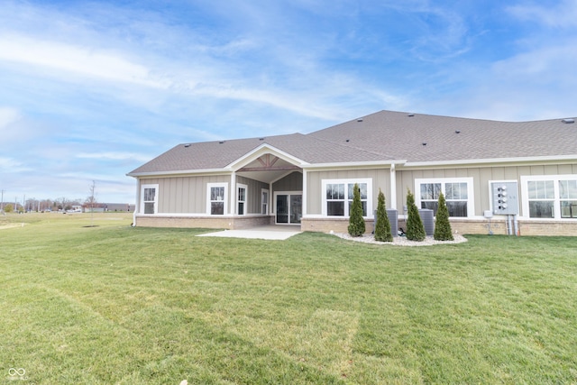 back of house featuring a lawn and a patio area