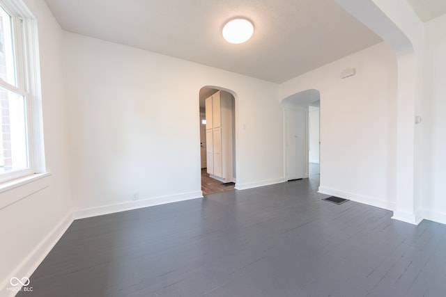 unfurnished room featuring dark hardwood / wood-style flooring