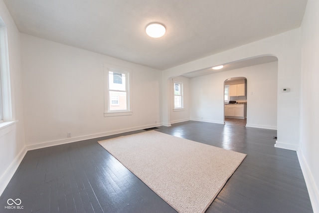 unfurnished room featuring dark wood-type flooring