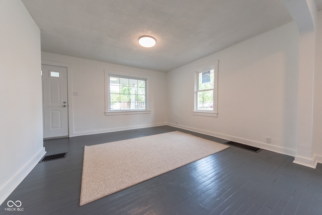 unfurnished room with dark hardwood / wood-style flooring