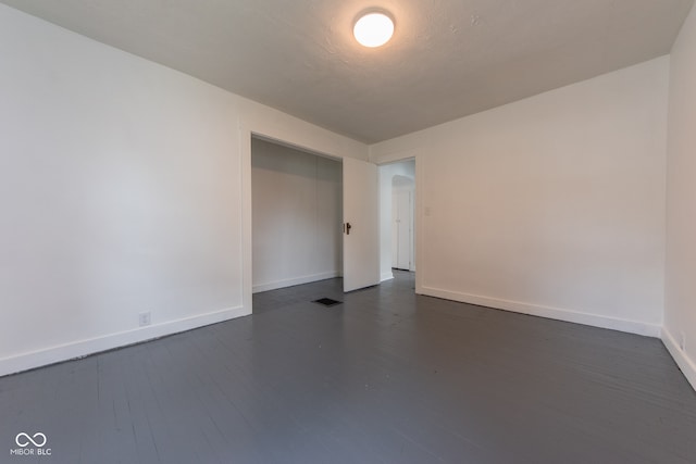 unfurnished room featuring dark hardwood / wood-style flooring