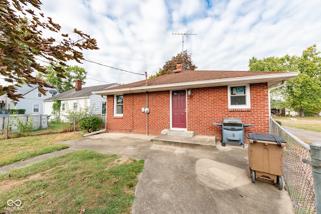 view of front facade with a patio and a front lawn