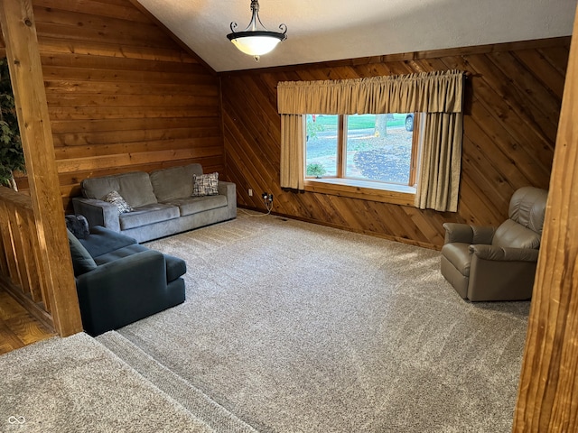 unfurnished living room with vaulted ceiling, a textured ceiling, wood walls, and carpet