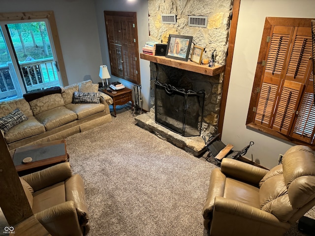 carpeted living room with a fireplace