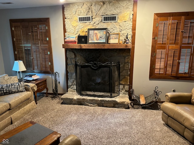 carpeted living room featuring a fireplace