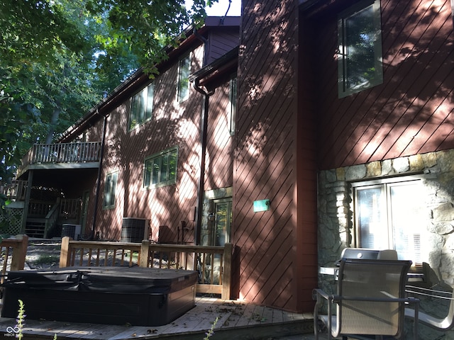 view of home's exterior with a balcony and cooling unit