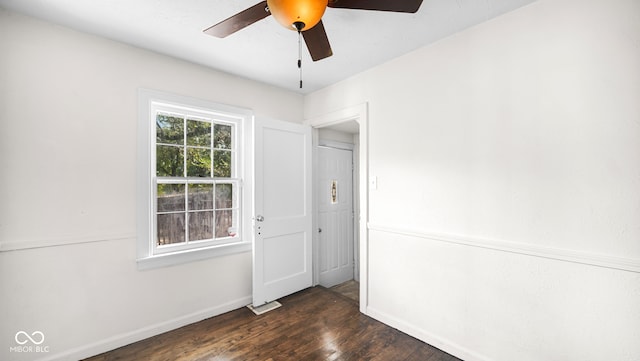 empty room featuring ceiling fan and dark hardwood / wood-style floors