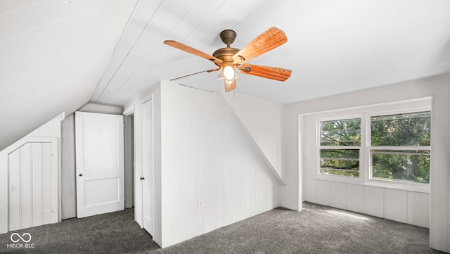 additional living space featuring lofted ceiling, ceiling fan, and dark colored carpet