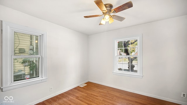 spare room featuring ceiling fan and light hardwood / wood-style flooring