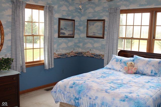 bedroom featuring carpet and multiple windows