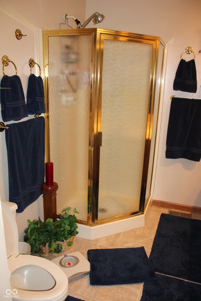 full bath featuring tile patterned flooring, toilet, visible vents, and a stall shower