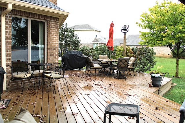 wooden terrace with grilling area and a yard