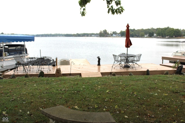 dock area featuring a lawn and a water view