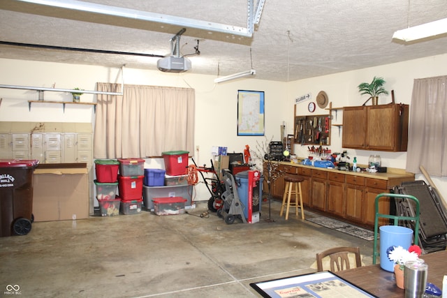 garage with a workshop area and a garage door opener