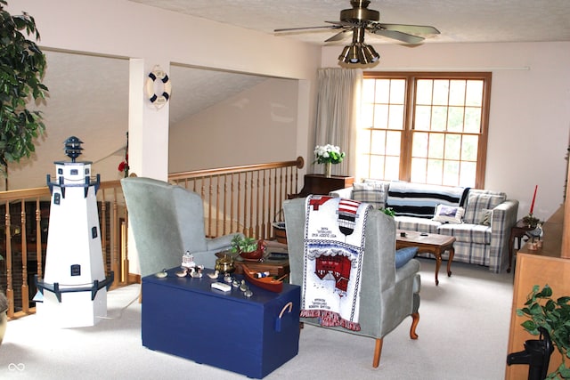 carpeted living room with a textured ceiling and ceiling fan