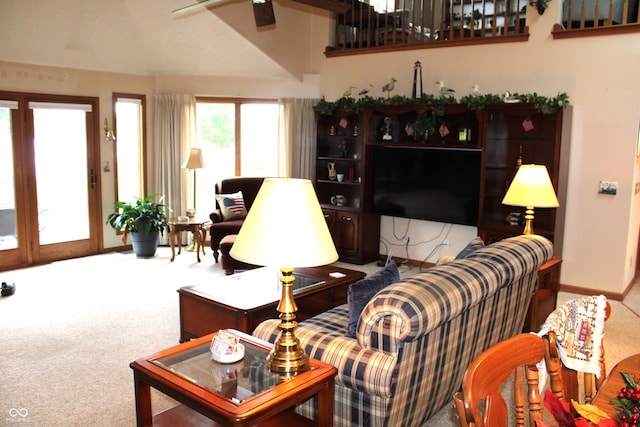 living area with baseboards, a ceiling fan, lofted ceiling, and carpet