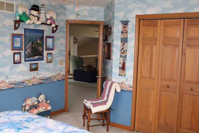 bedroom featuring a closet, visible vents, wallpapered walls, and baseboards