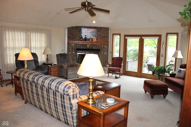 carpeted living room with lofted ceiling, ceiling fan, and a brick fireplace