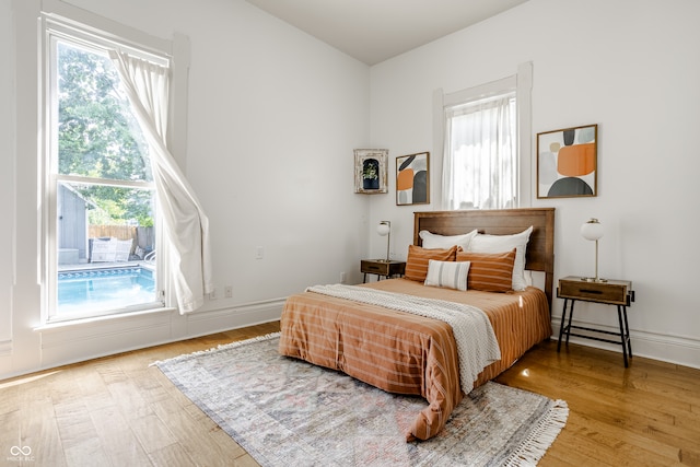 bedroom featuring light wood-type flooring and multiple windows