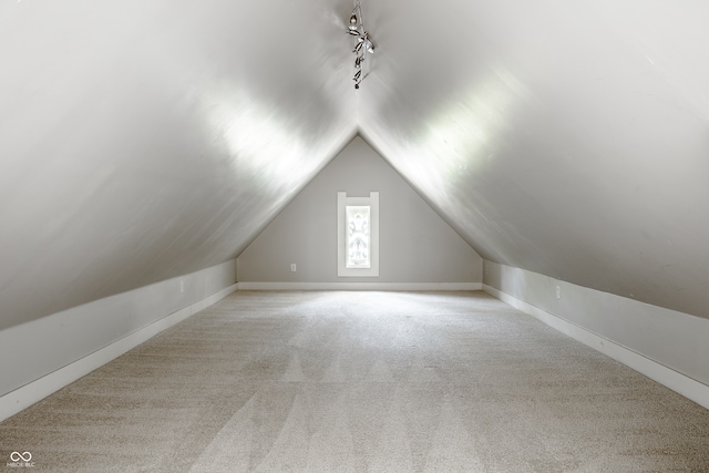 additional living space with lofted ceiling and light colored carpet