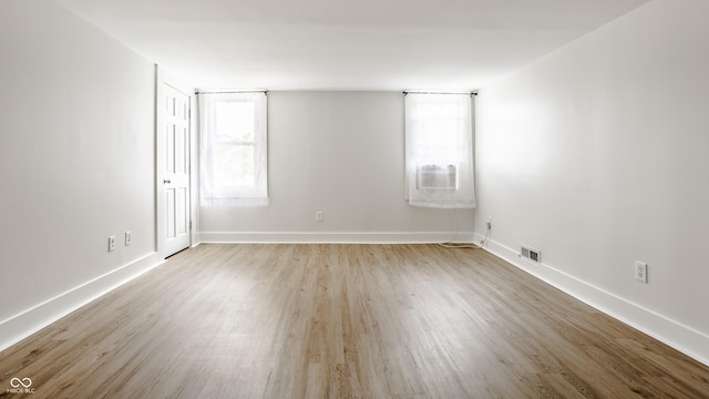 1715 Alabama St, Indianapolis, IN 46202 - spare room with baseboards, wood finished floors, and visible vents