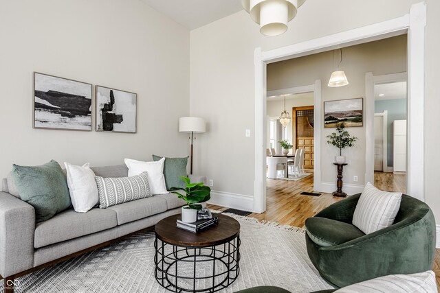 1715 Alabama St, Indianapolis, IN 46202 - living room with baseboards, wood finished floors, and a chandelier