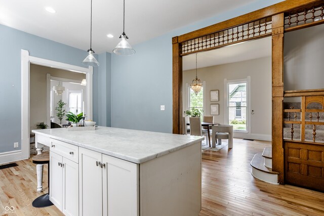 1715 Alabama St, Indianapolis, IN 46202 - kitchen featuring white cabinets, light wood finished floors, pendant lighting, and recessed lighting